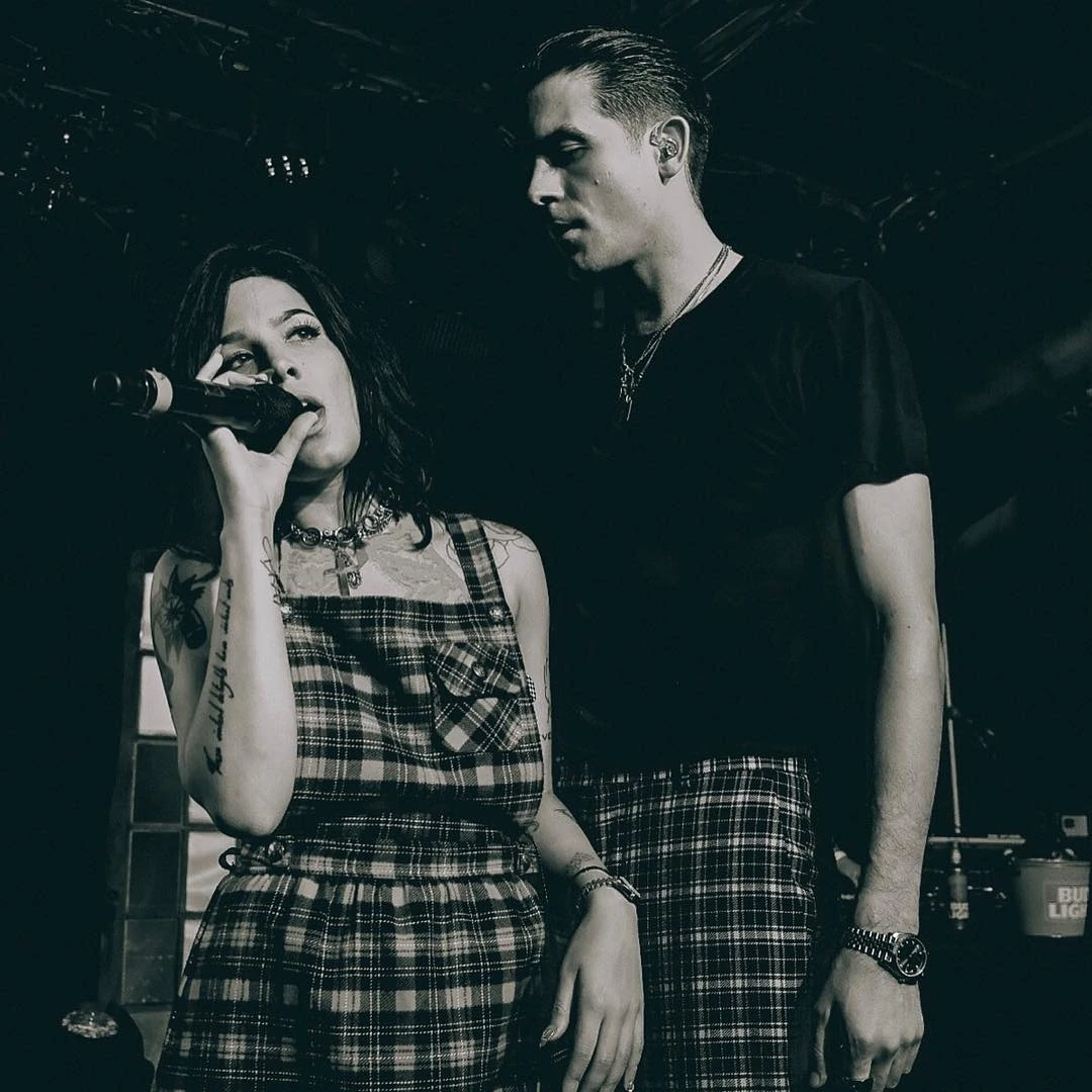 Halsey performing beside G-Eazy wearing layered necklaces