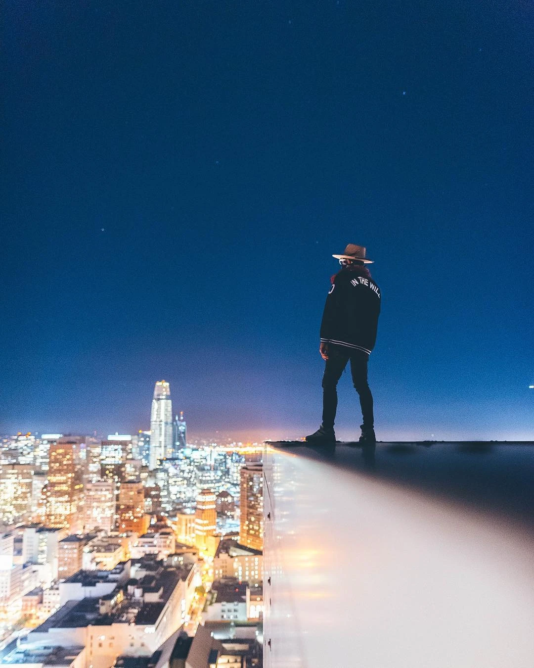A Friend of Frank standing above the San Francisco skyline at night